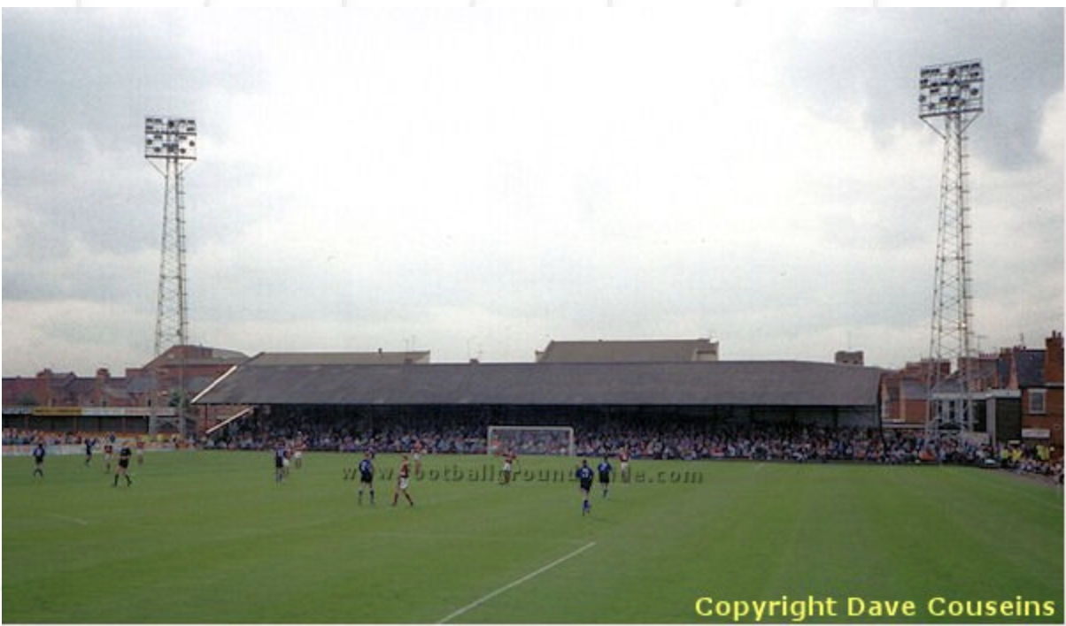 The County Ground, with supporters in the stand and players on the pitch